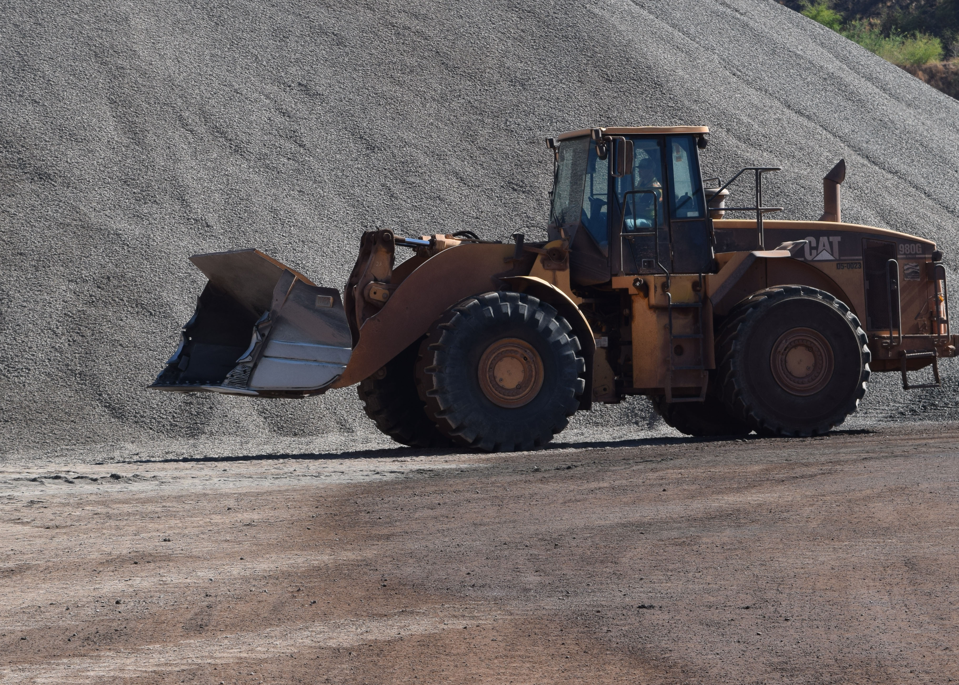 Loader moving aggregate material at a local quarry